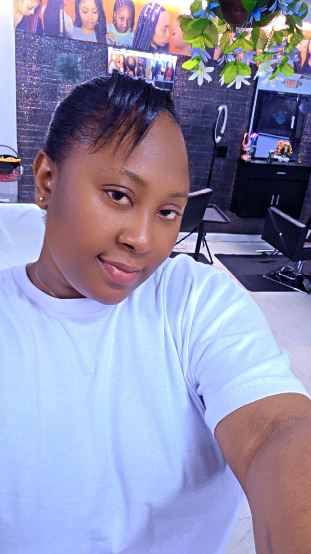 Ida African Beauty Salon stylist showcasing cornrow braids